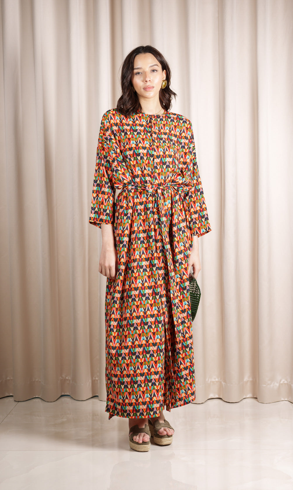 Model wears silk crepe blend dress featuring an exquisite multi-coloured print