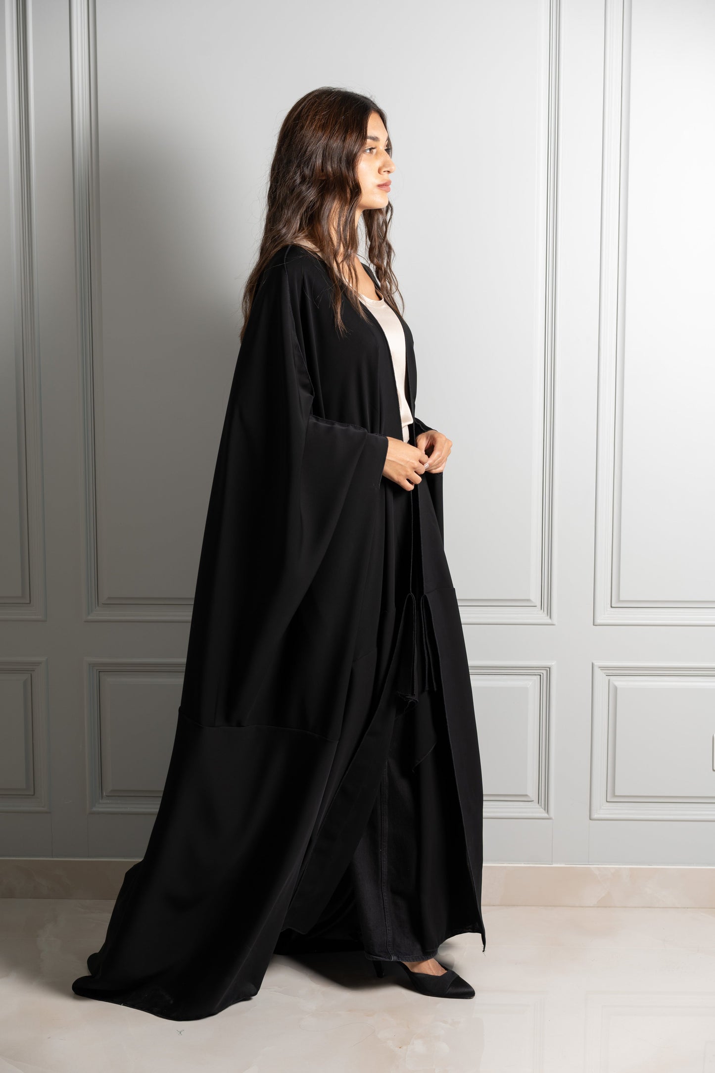 Model wears black abaya paired with silk top
