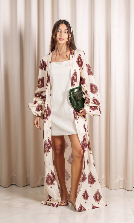 Model wears luxurious kimono features an exquisite Aztec print in rich burgundy and green hues