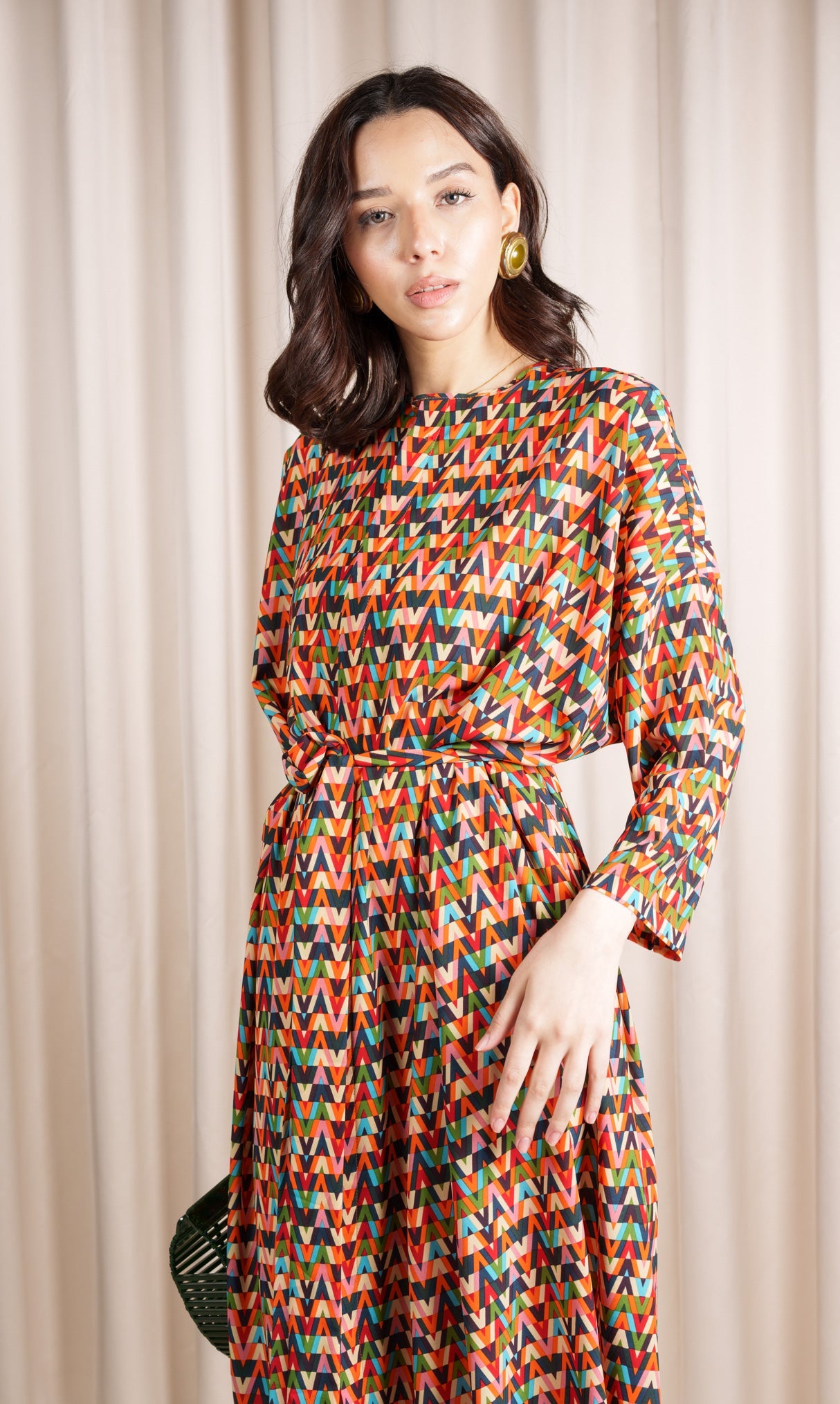 Model wears silk crepe blend dress featuring an exquisite multi-coloured print