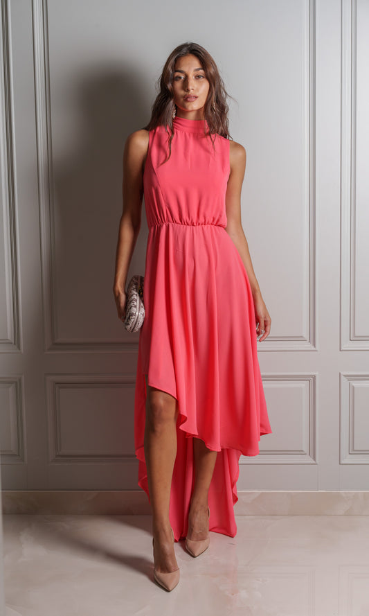 Model wears chiffon fabric dress, lightweight and airy texture drapes softly against the skin in a coral peach colour