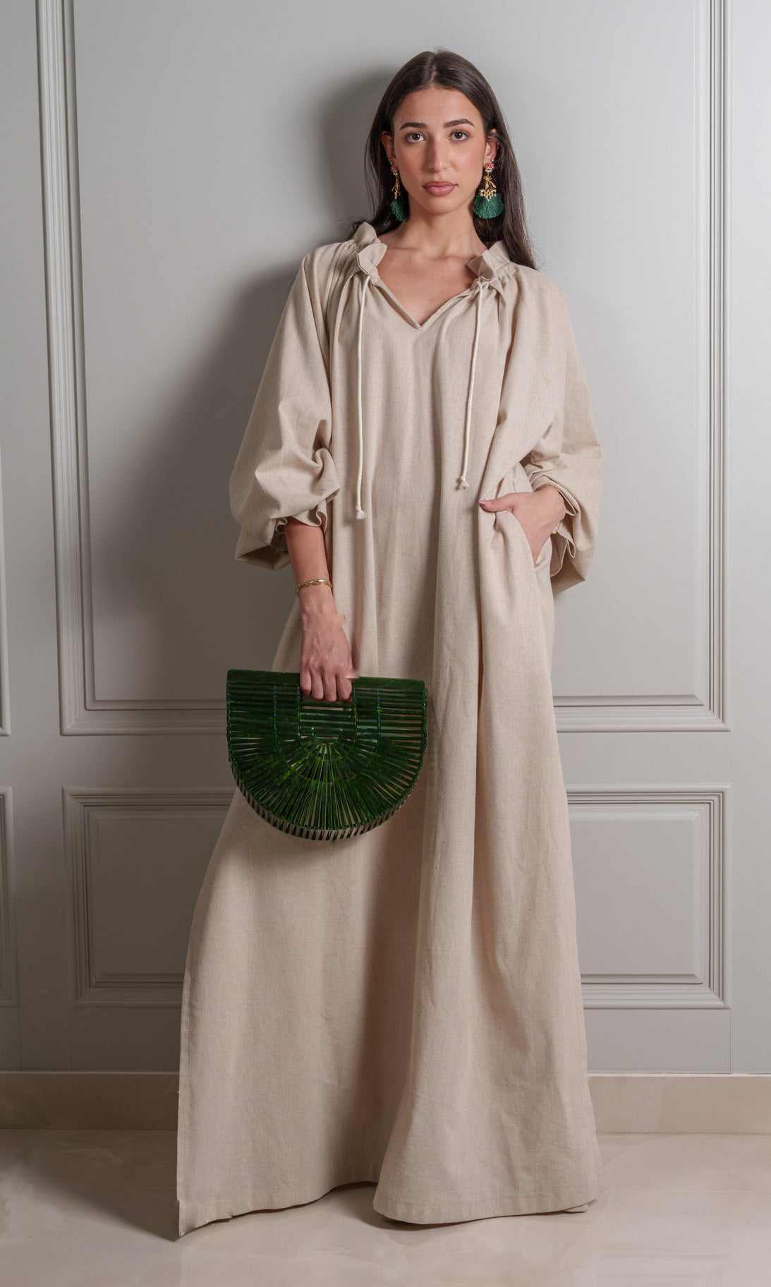 Model wears robe made of breathable linen fabric in a versatile neutral beige hue