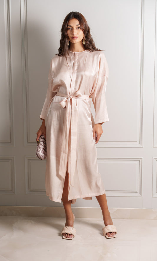 Model wears robe in silky pink crepe blend fabric with a delicate shimmer