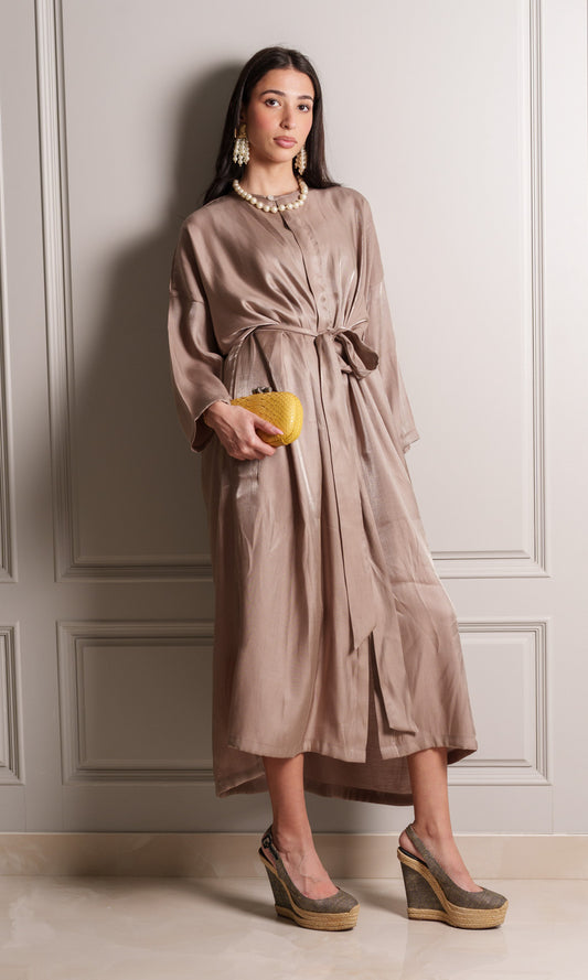 Model wears silky crepe blend fabric in a shade of light taupe with a delicate shimmering finish