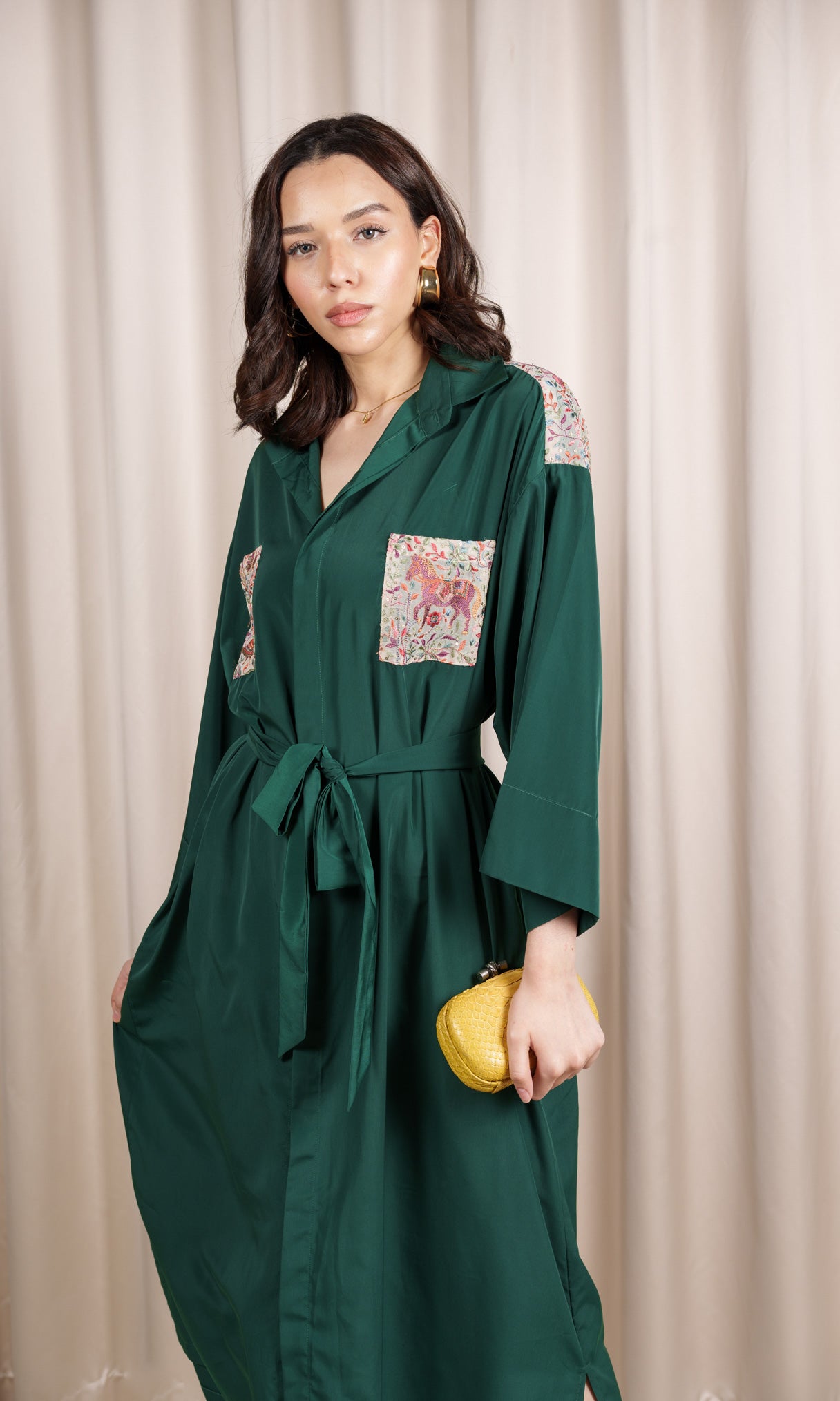 Model wears green shirt dress with pattern details