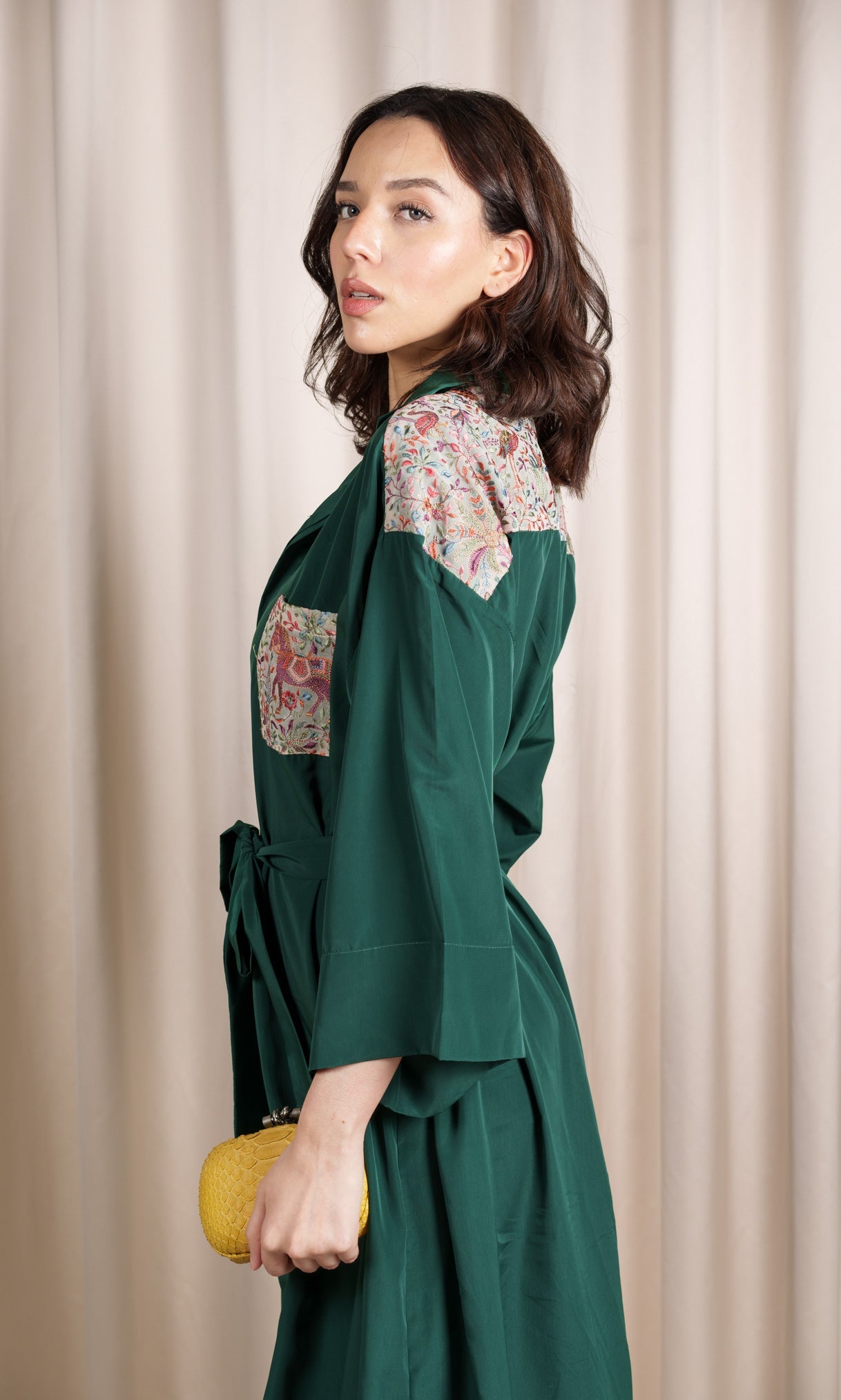 Model wears green shirt dress with pattern details