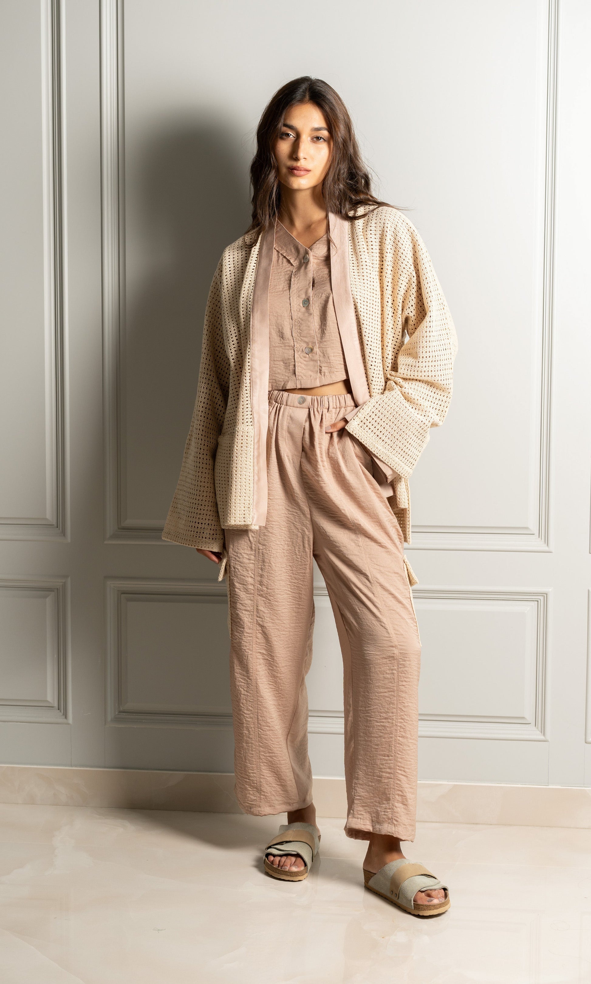 Model wears three-piece set includes a luxurious satin blend button-up shirt, paired with relaxed-fit trousers that feature an elasticated waistband