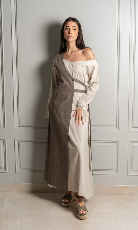 Model wears dress in linen fabric in a harmonious blend of two earthy tones.